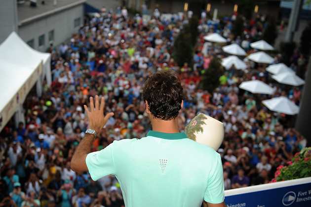 Federer poses with the winner's trophy on Champion's Balcony after his final match against David Ferrer in the Western & Southern Open.